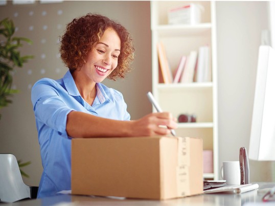 GLS employee preps a parcel for shipping