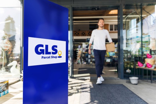 man walking from a gls parcel shop