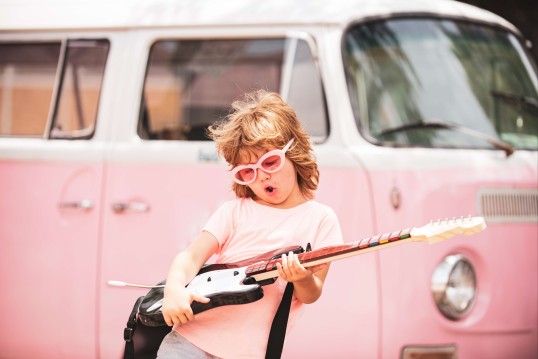 kid plays guitar