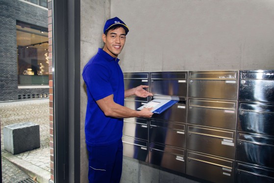 GLS deliveryman deliver parcel to customer at home 