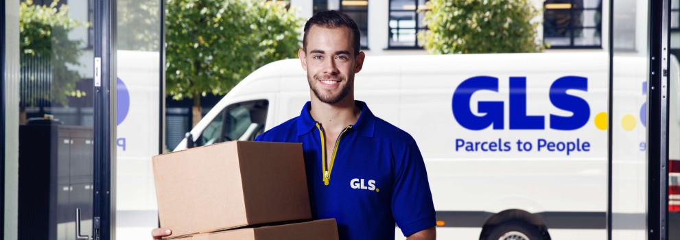 GLS courier delivers a parcel to an office building
