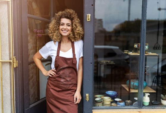 Young woman waiting for GLS delivery in front of her store