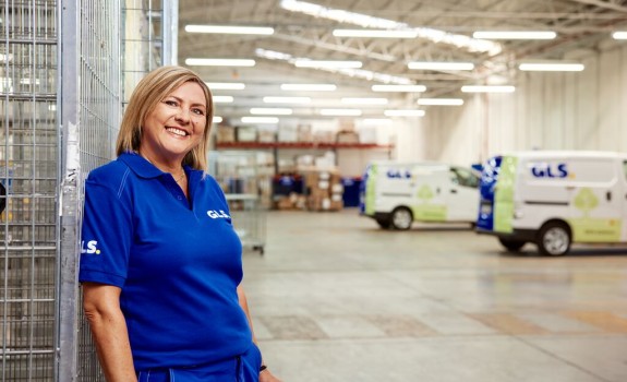 GLS courier woman stands in a GLS depot