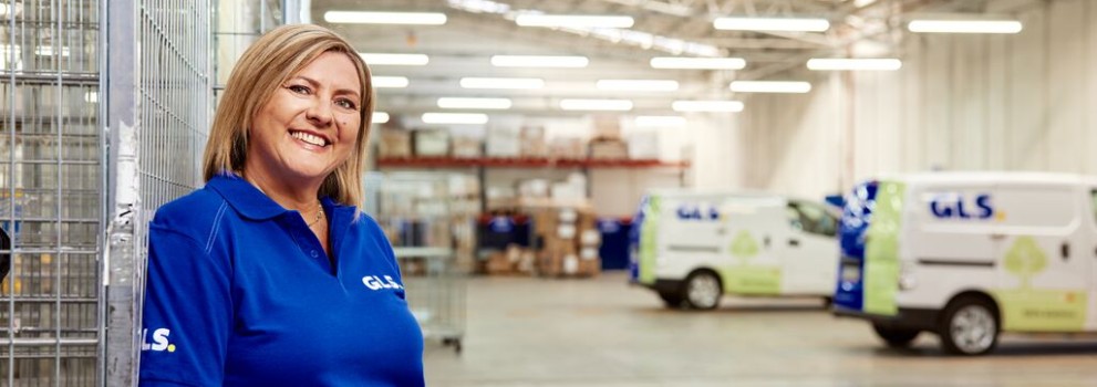 GLS courier woman stands in a GLS depot