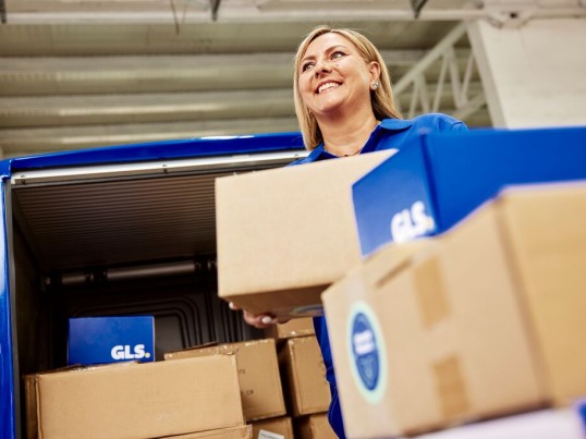 Women courier preparing parcels for delivery