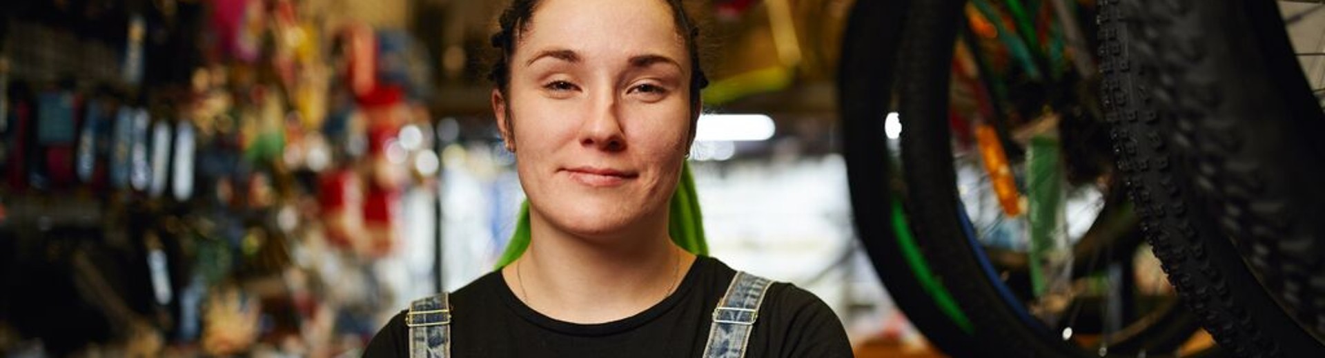 Customer stands with folded arms in a store