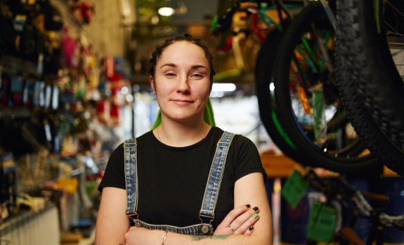 Customer stands with folded arms in a store