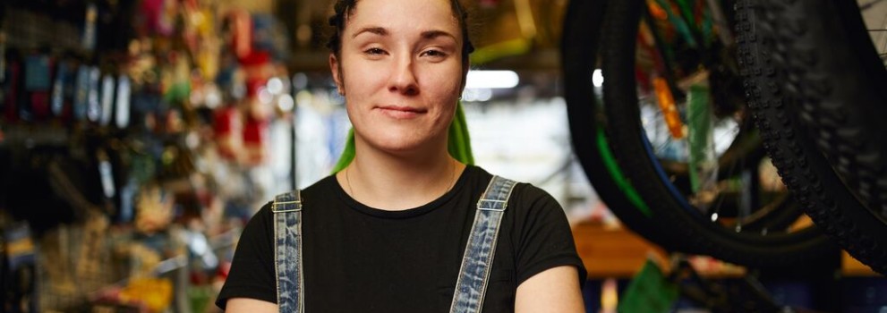 Customer stands with folded arms in a store