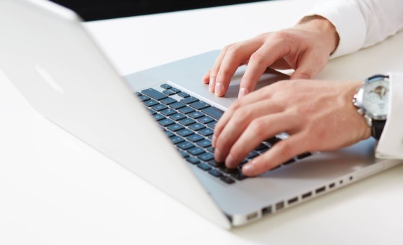 Man typing on laptop