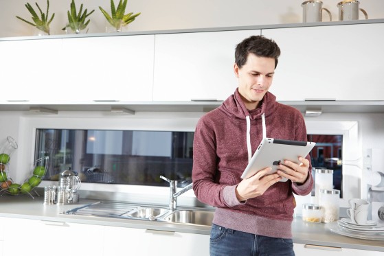 Man standing and looking at the tablet