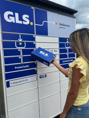 Customer next to GLS Parcel Locker with parcel