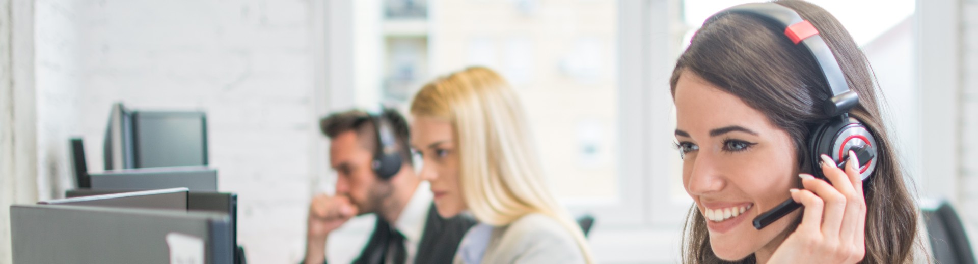 Customer service agent smiling with a headset.